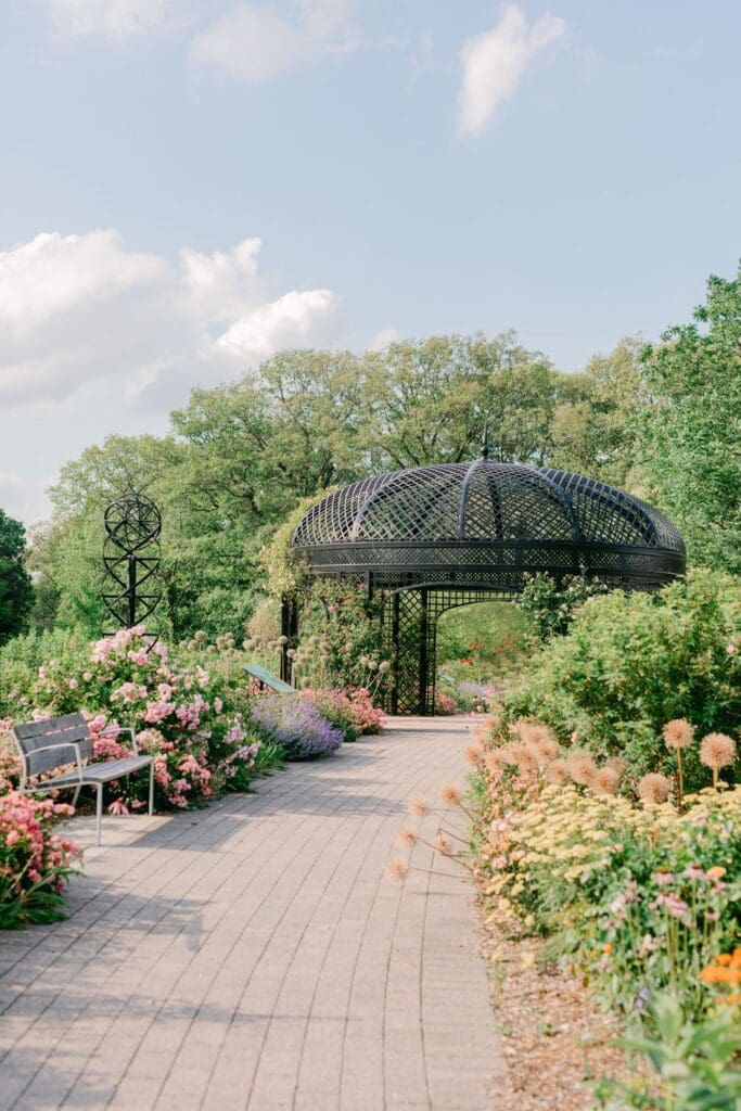 Blooming botanical garden path with black wrought iron gazebo at Burlington Botanical Gardens.